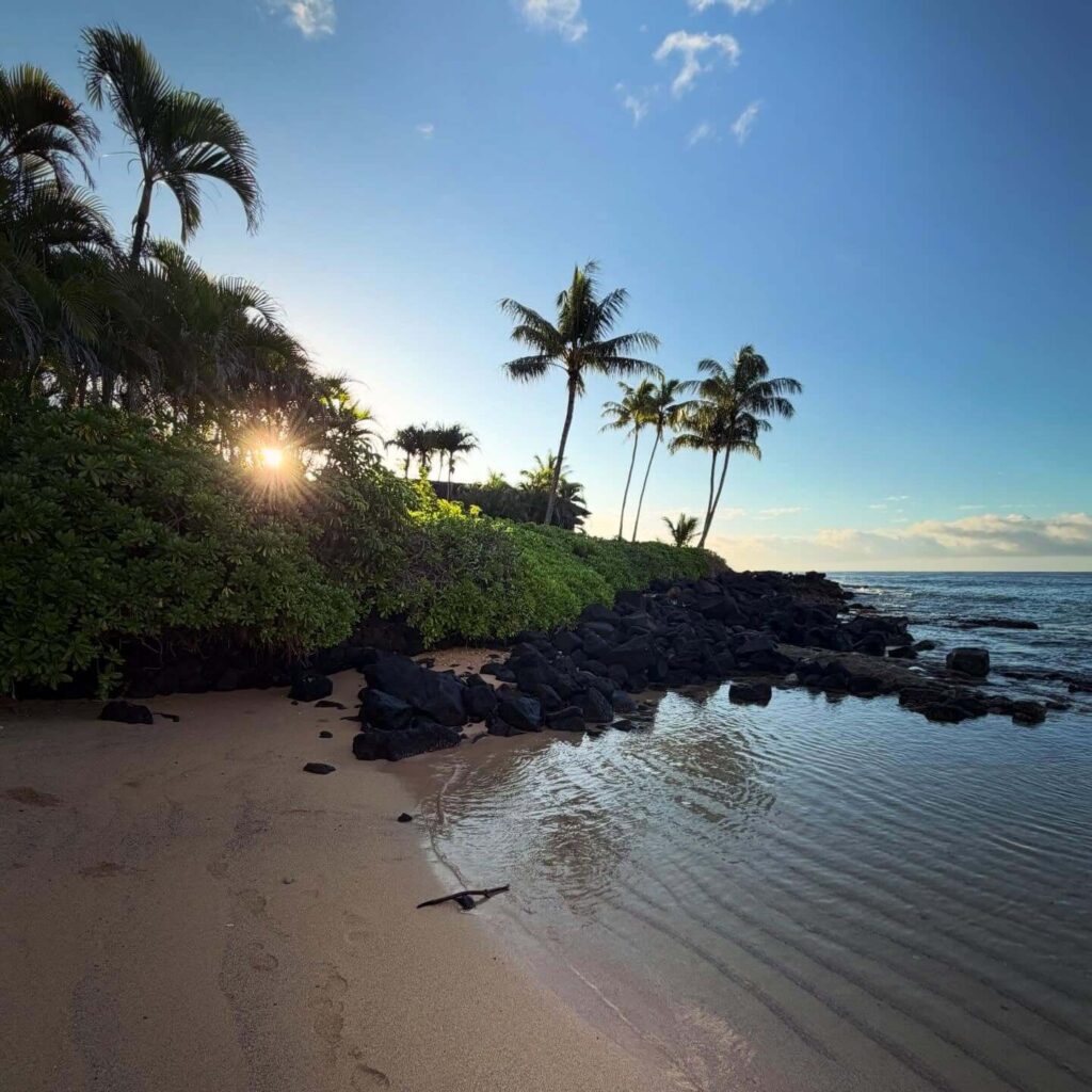 Calm turquoise water and golden sand at Poipu Beach on Kauai's South Shore