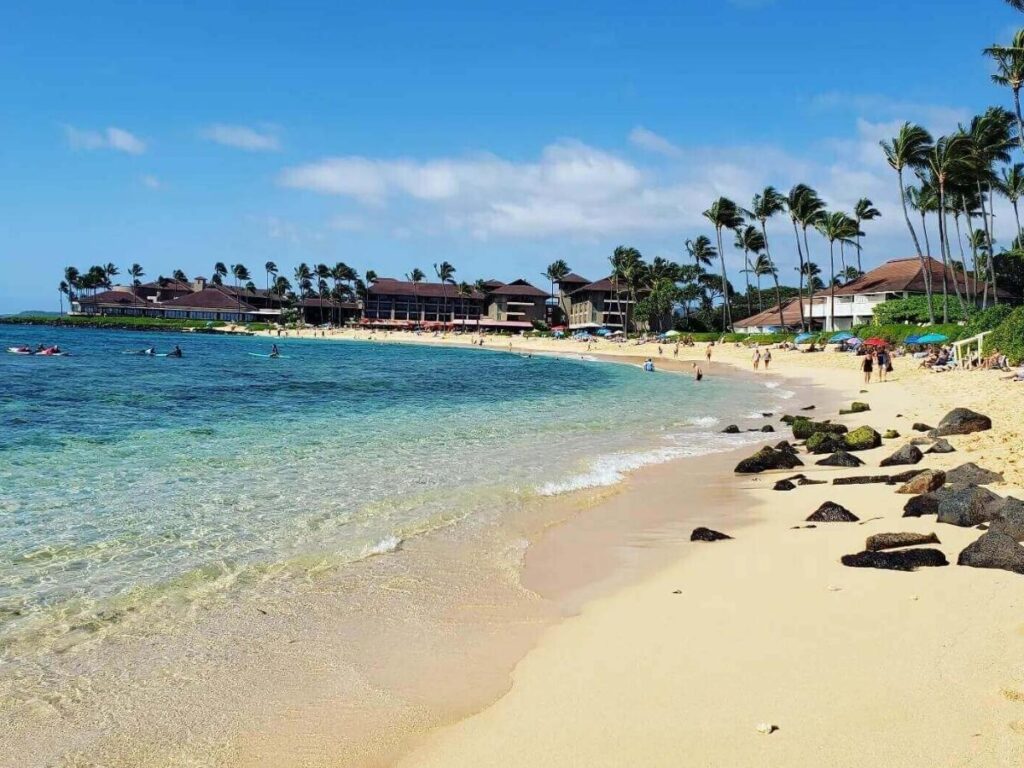 Poipu Beach on Kauai South Shore with calm water and palm trees