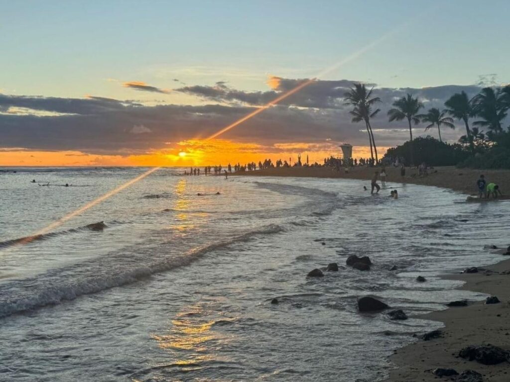 Sunny beach scene in Poipu on Kauai’s South Shore with calm waters