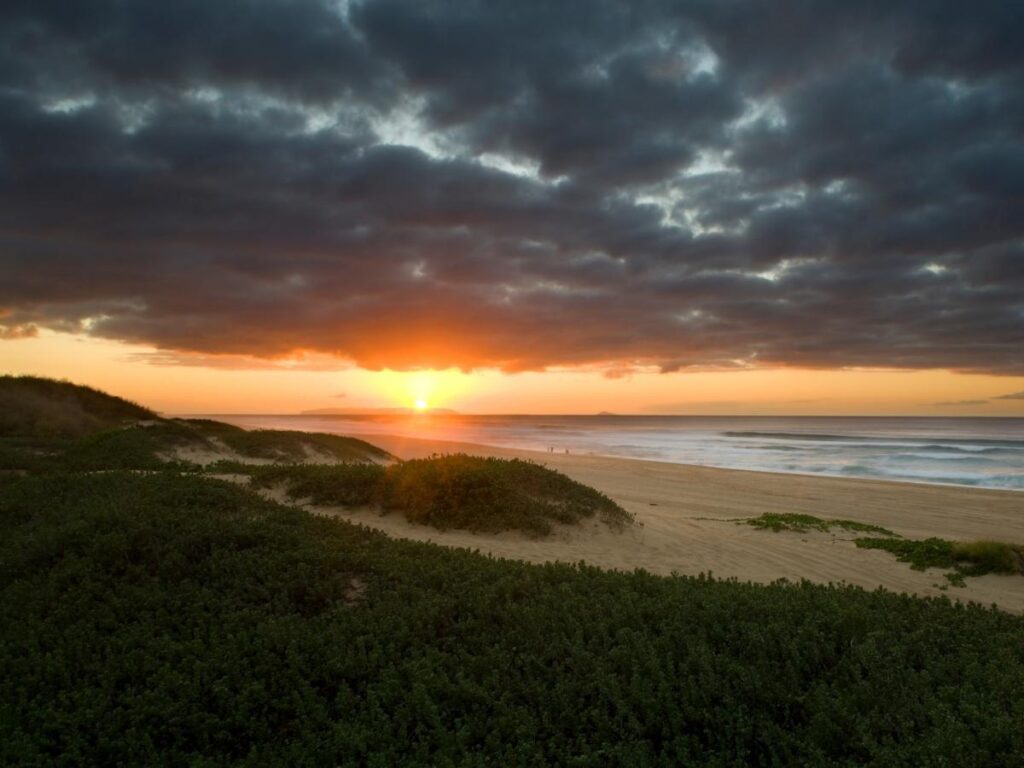 Sunset over Polihale Beach with colorful skies and the Pacific Ocean