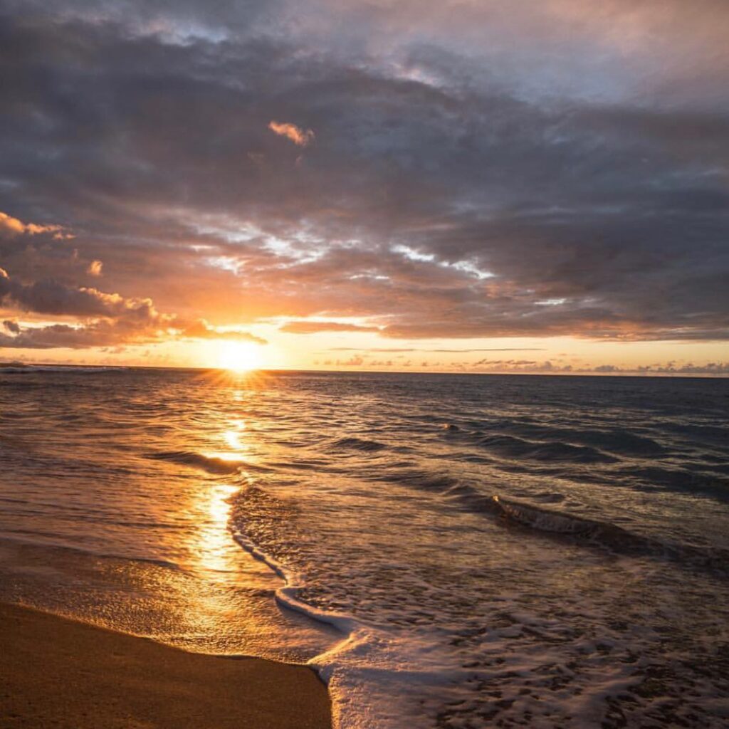 Sunset over Polihale Beach on Kauai with colorful skies and ocean views