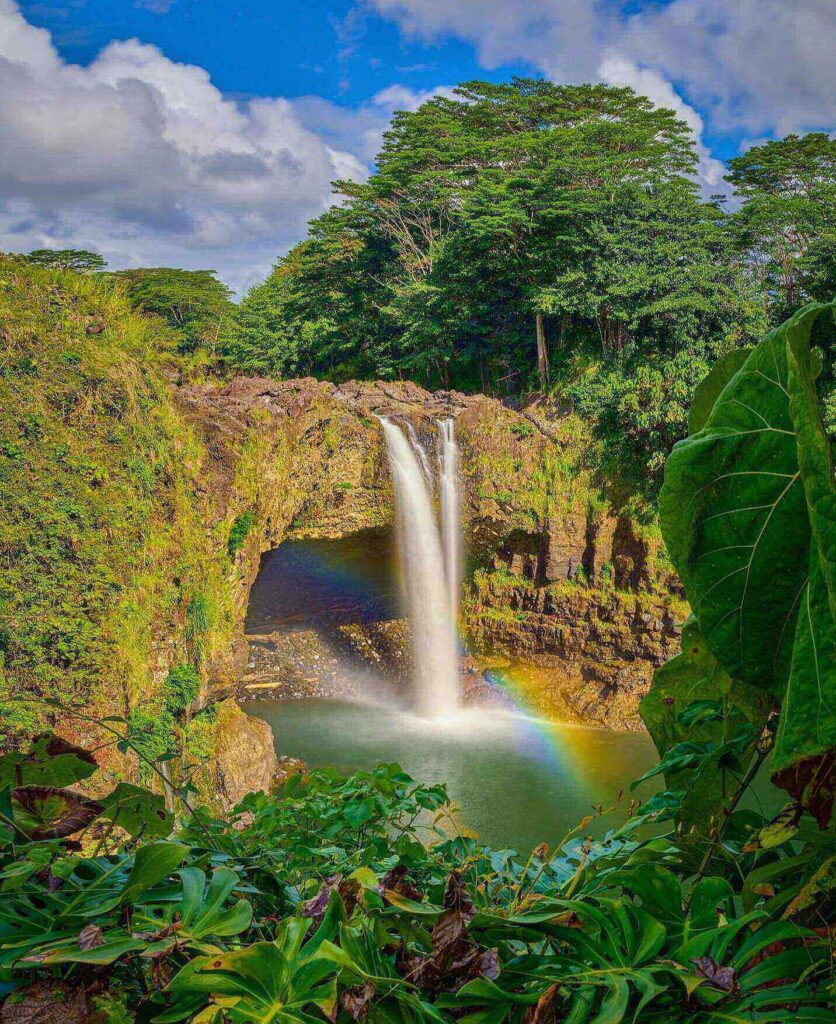 Rainbow Falls waterfall surrounded by tropical forest in Hilo on the Big Island