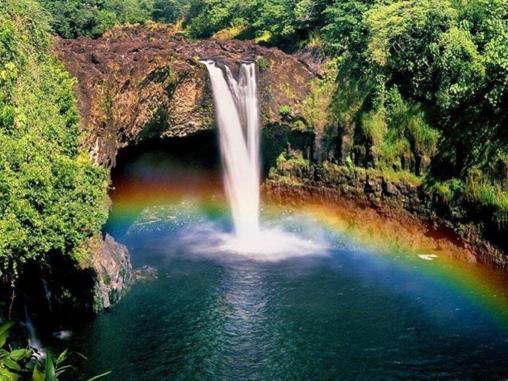 Rainbow Falls waterfall surrounded by tropical forest in Hilo on the Big Island