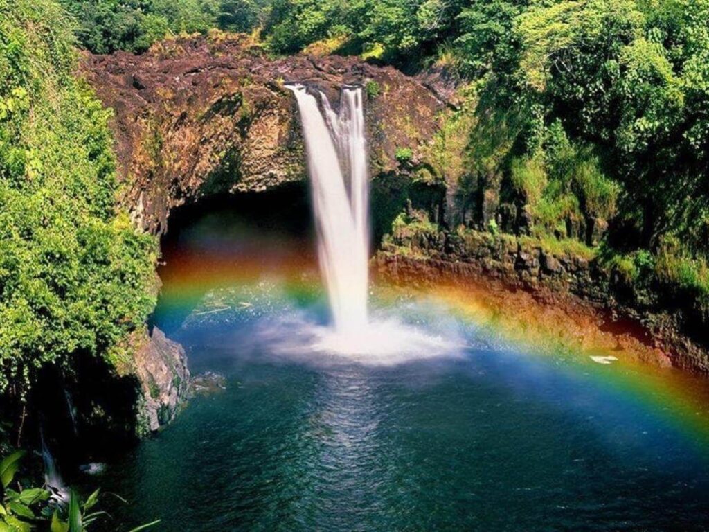 Rainbow Falls in Hilo Hawaii with rainbow forming in the mist