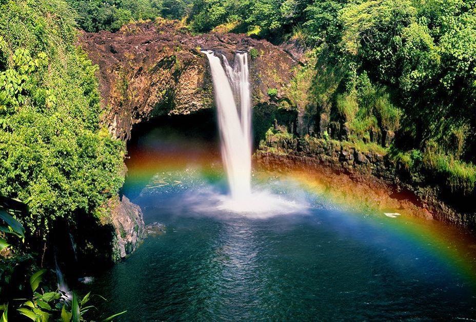 Morning view of Rainbow Falls with a rainbow forming in the mist