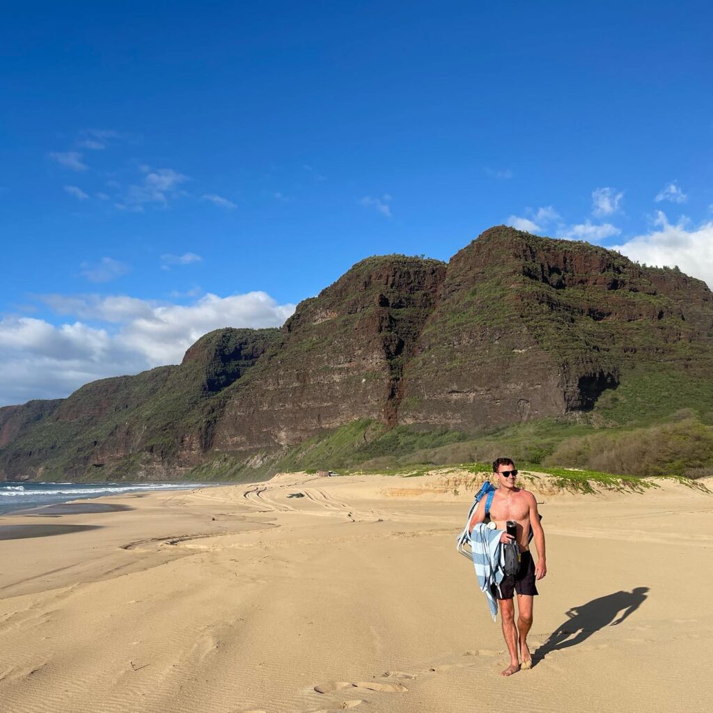 Visitors relaxing on the sandy beach at Polihale State Park on Kauai