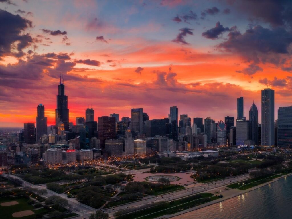 Person relaxing along the Lake Michigan shoreline with the Chicago skyline in the distance