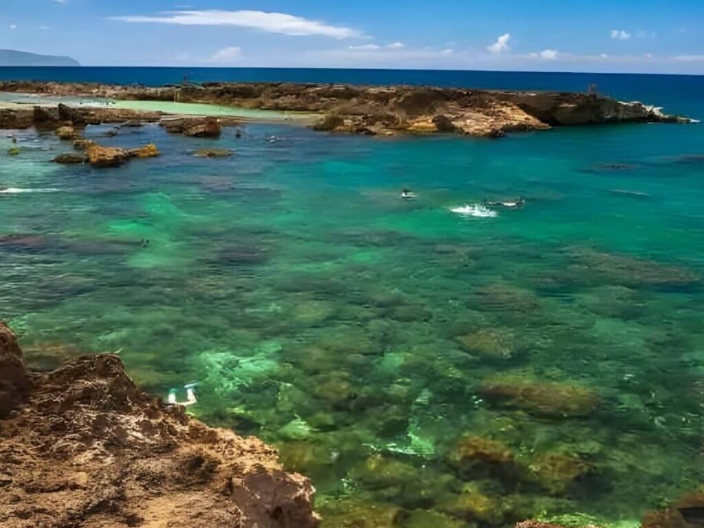 Rocky shoreline and clear summer water at Shark’s Cove on Oahu’s North Shore