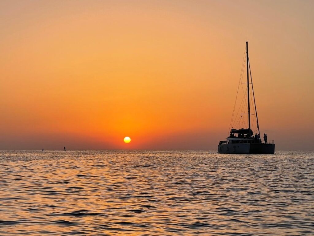 Catamaran sailing at sunset along the Kohala Coast near Waikoloa