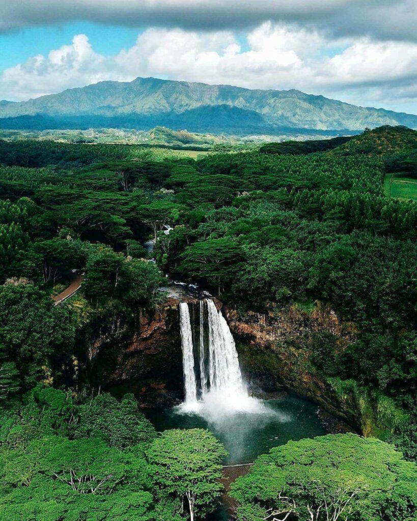 Wailua Falls flowing into a lush tropical valley on Kauai