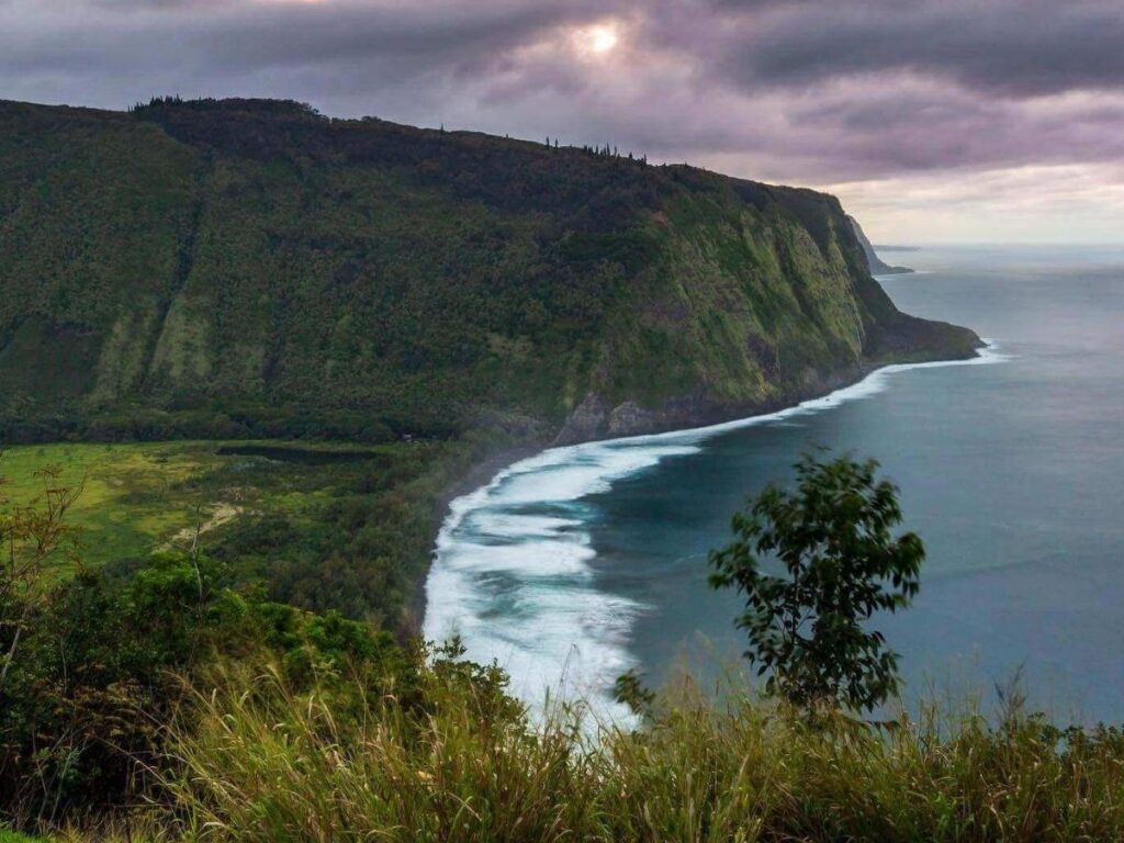 View of Waipio Valley with steep cliffs and waterfalls on the Big Island of Hawaii