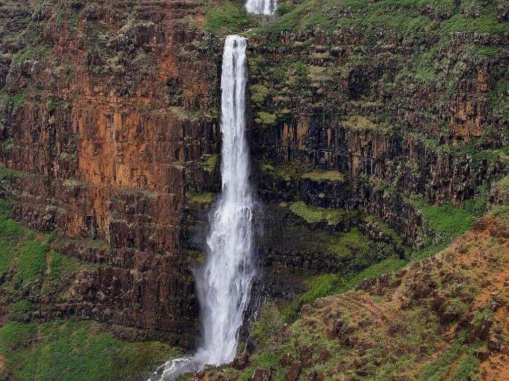 Waipoo Falls flowing into Waimea Canyon in Kauai Hawaii