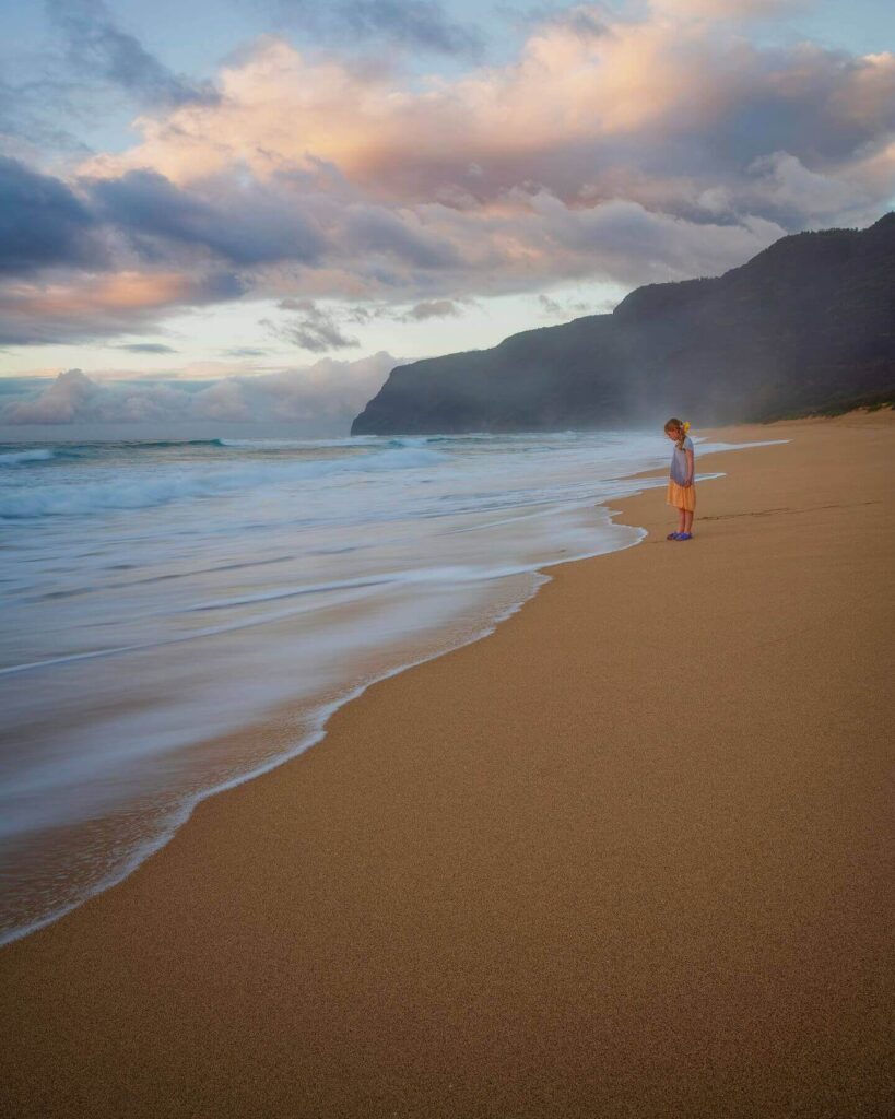Golden sand, towering dunes, and views of the Nā Pali Coast at Polihale State Park during sunset