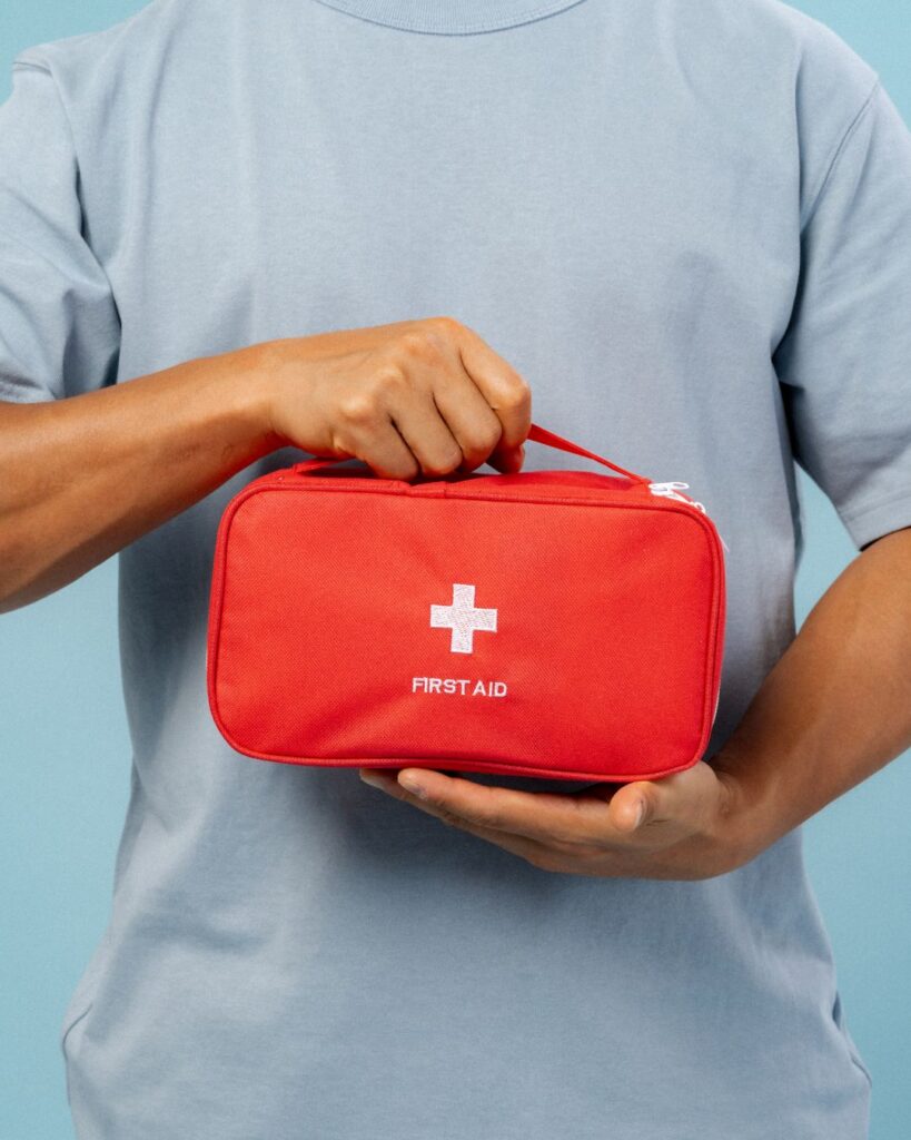 A traveler holding a mini first-aid kit