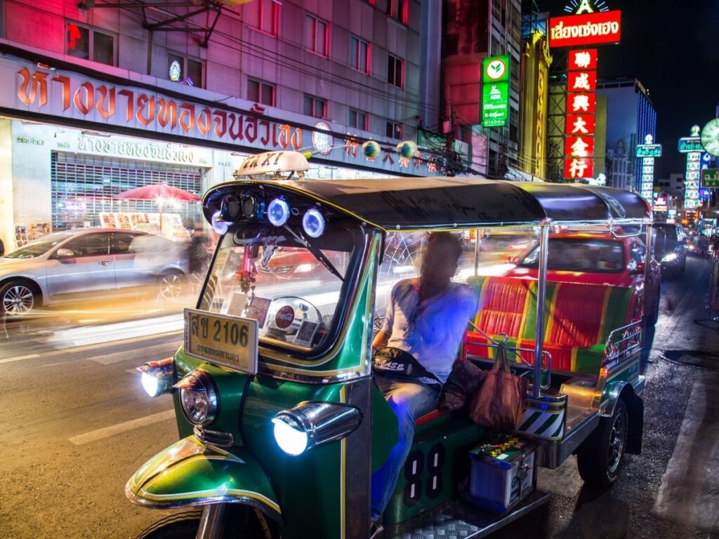 Bangkok street scene with tuk-tuks and Thai signs