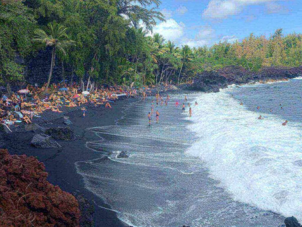 Black sand beach on the Big Island with volcanic shoreline and ocean waves