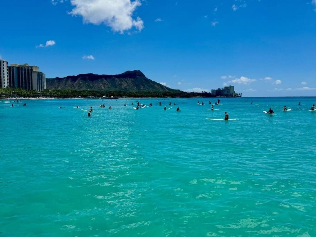 Calm turquoise water at a sandy beach in Hawaii ideal for swimming