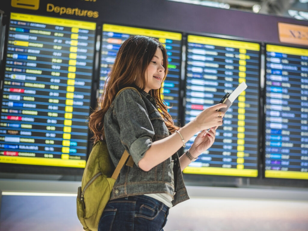 Traveler booking flights at the airport