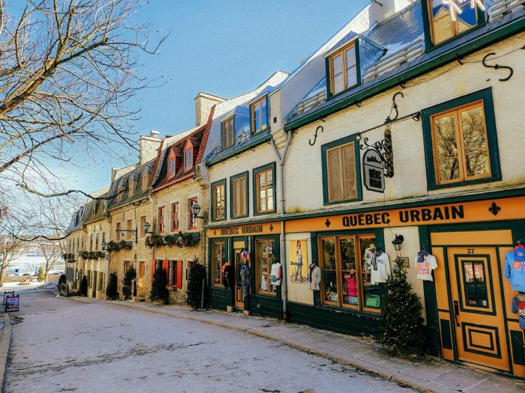 Empty cobblestone street with closed shop shutters