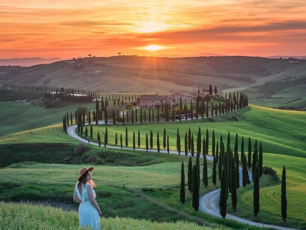 Remote road winding through the dramatic clay hills of Crete Senesi