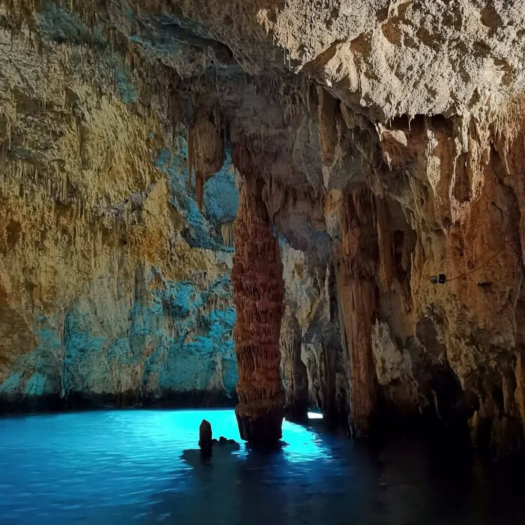 Rowboat inside Grotta dello Smeraldo with emerald glowing water