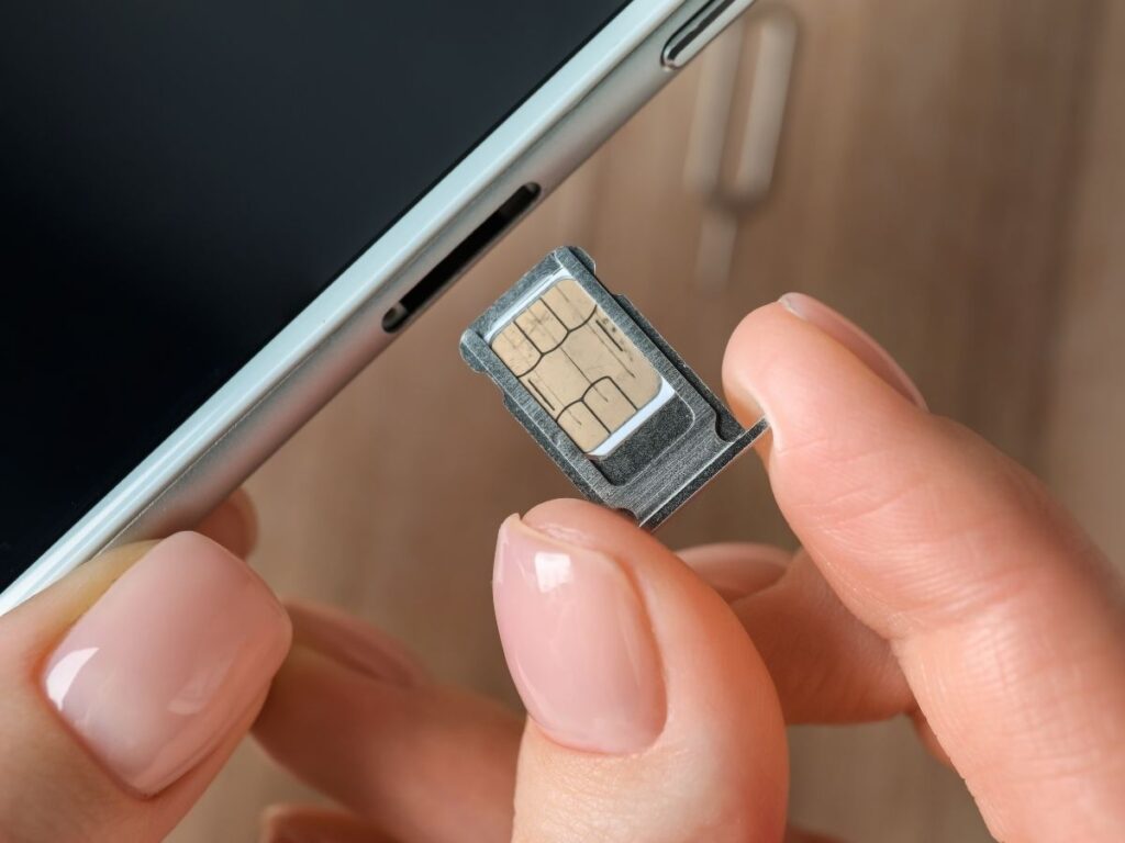 Person inserting SIM card into phone