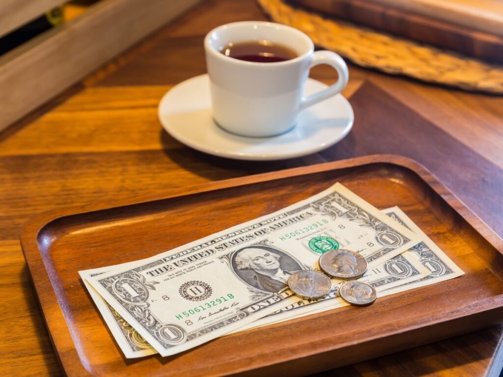 Small euro coins left as a tip on a cafe table