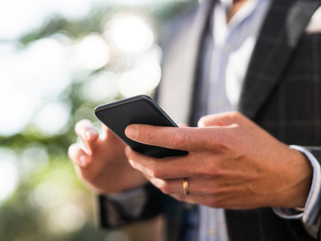 Checking a flight deal alert email on a smartphone