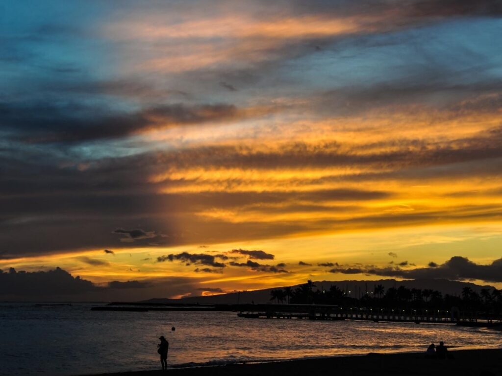 Palm trees and a peaceful sunset at Fort DeRussy Beach in Waikiki