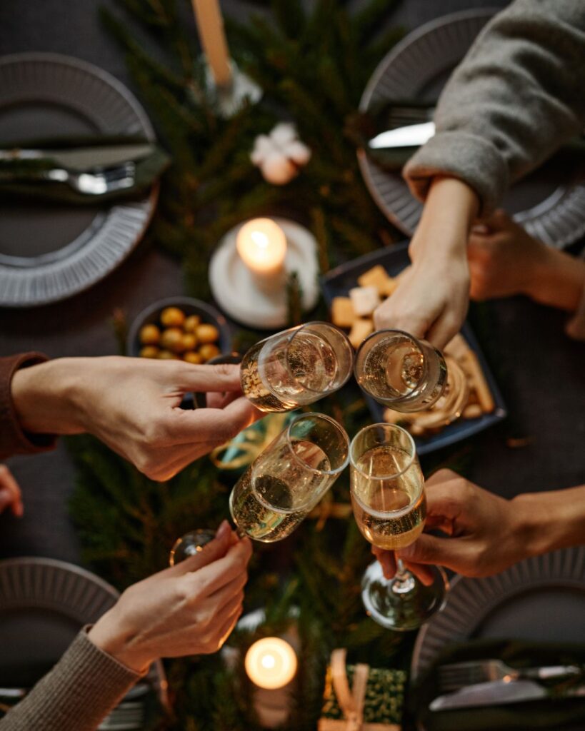 Group of friends sharing champagne in a luxury hotel suite