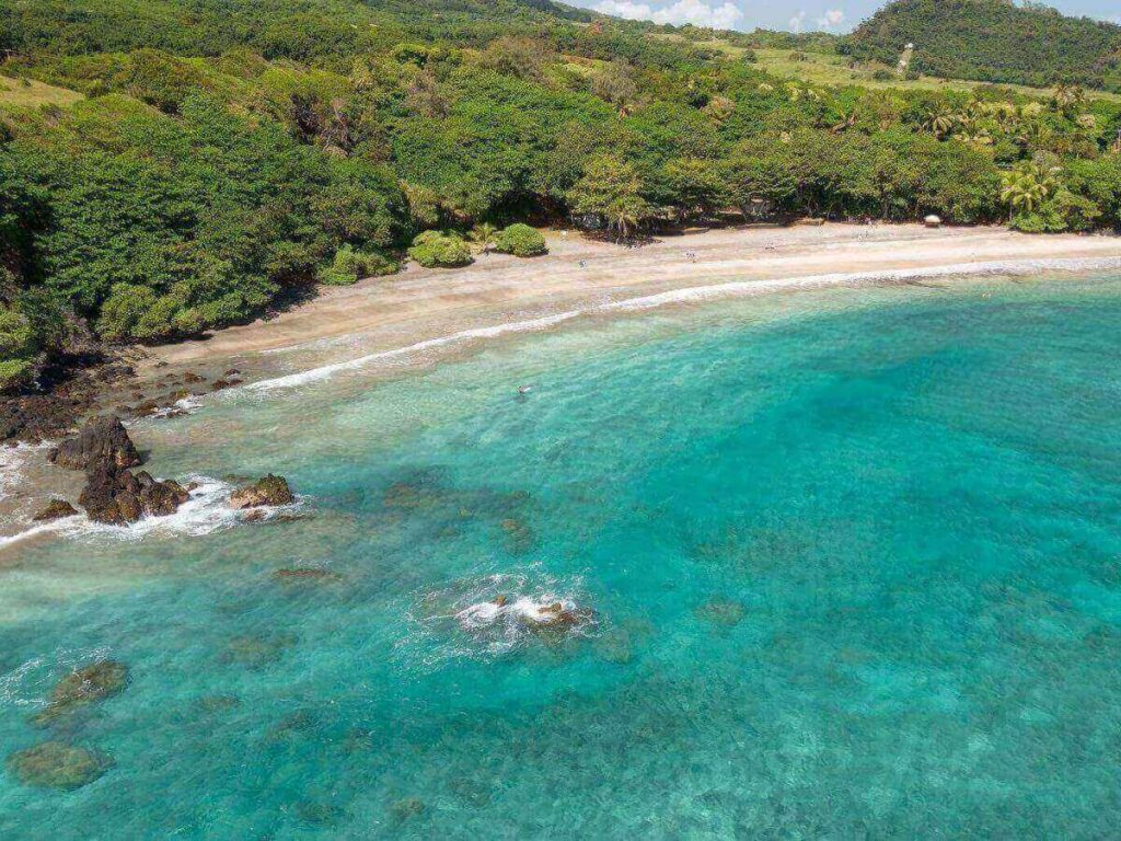 Hamoa Beach along the Road to Hana in Maui surrounded by lush cliffs