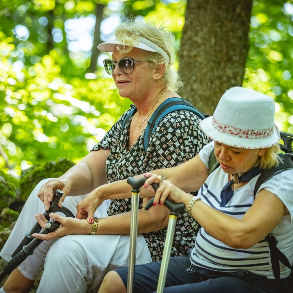 Older hikers resting and enjoying a mountain view
