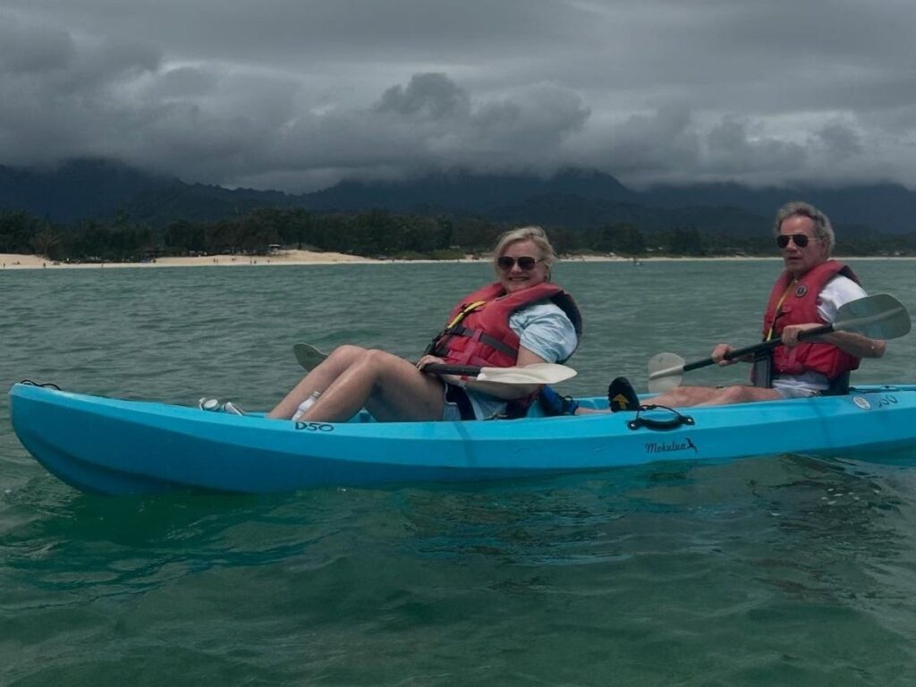 Wide sandy shoreline at Kailua Beach on Oahu with calm water and kayaks along the shore
