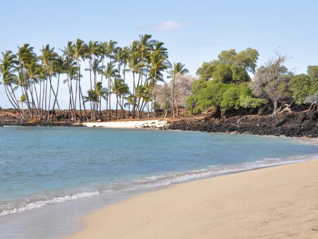 Quiet sandy beach inside Kekaha Kai State Park in Hawaii