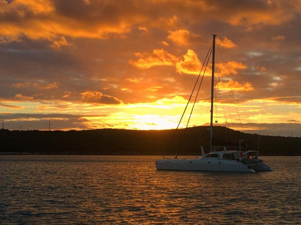 Catamaran sailing at sunset off Kapolei Oahu coast