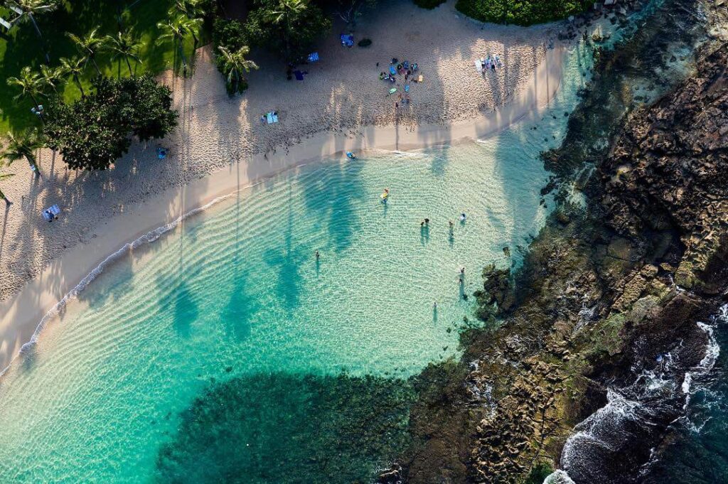 People relaxing in calm lagoon water in Kapolei Oahu