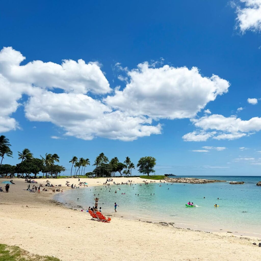 Calm lagoon beach in Ko Olina Kapolei with clear water and palm trees