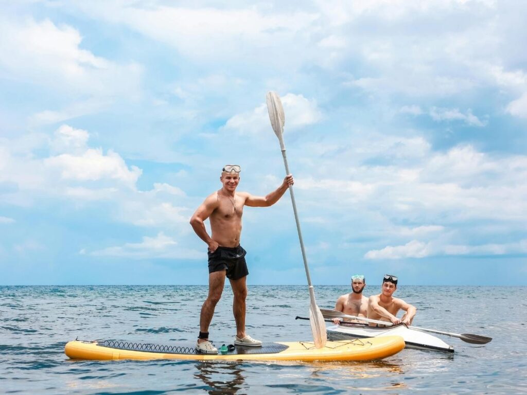 Person paddle boarding in calm lagoon water in Kapolei