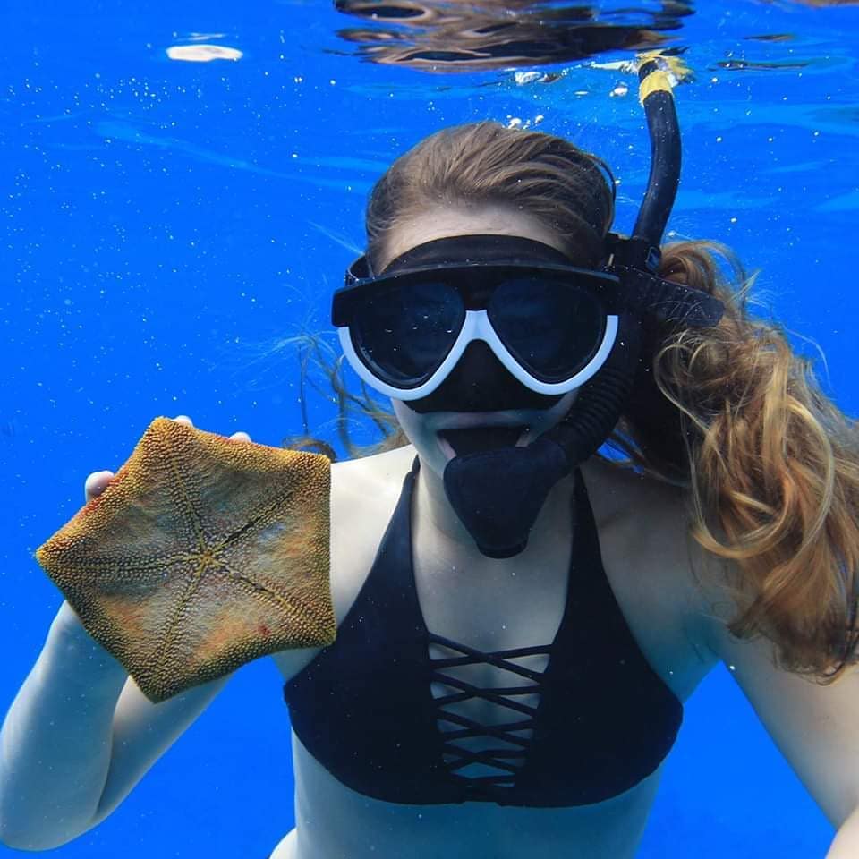 Snorkeling near rocky edge of lagoon in Kapolei Oahu