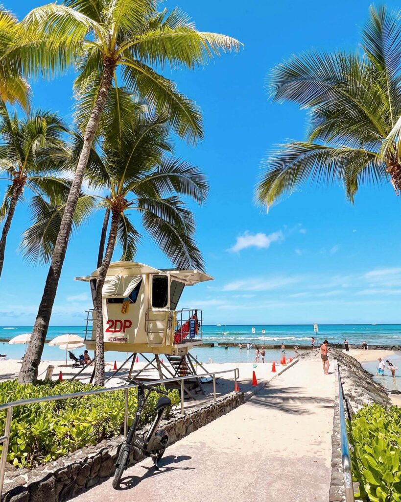 Calm waters at Kuhio Beach Park with visible breakwater