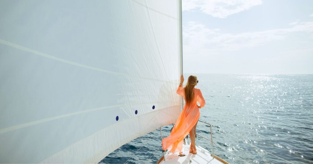 Woman looking out over ocean from a luxury boat