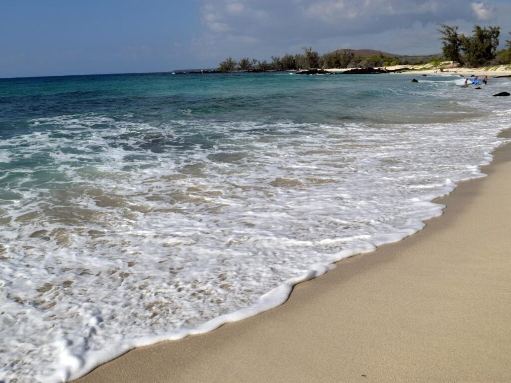 Pale sand and clear water at Makalawena Beach on the Big Island