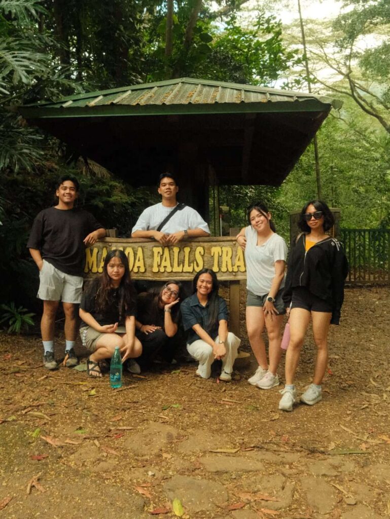 Visitors hiking through the rainforest on the Manoa Falls Trail