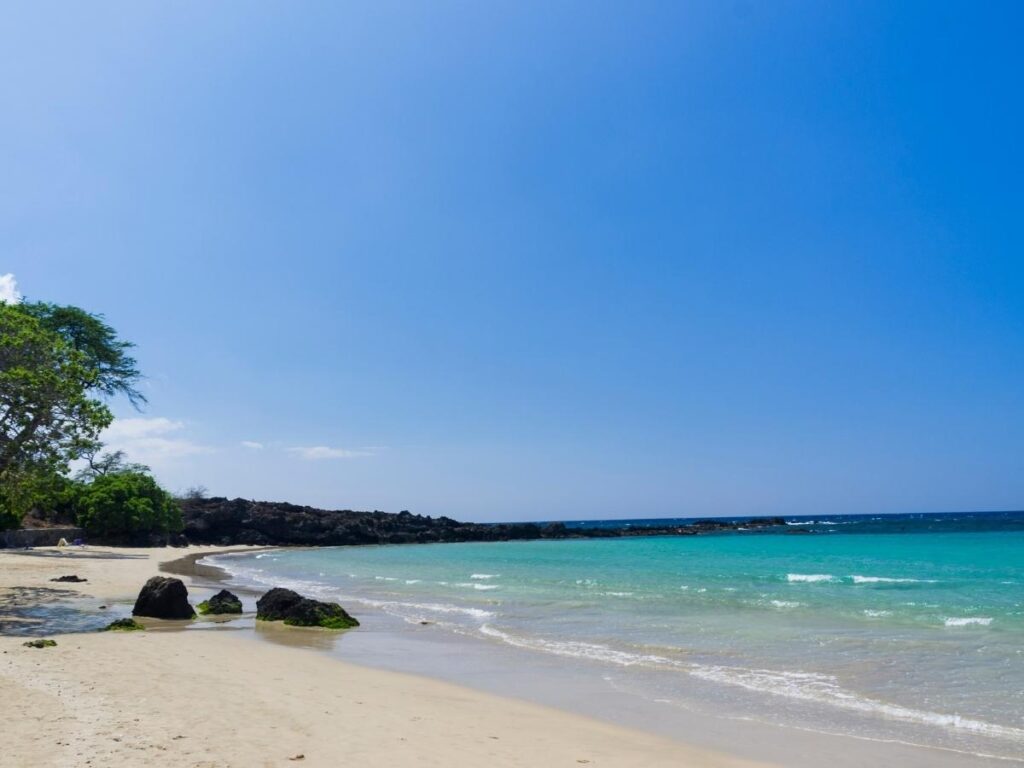 Mauna Kea Beach on the Big Island with calm water in a crescent shaped bay