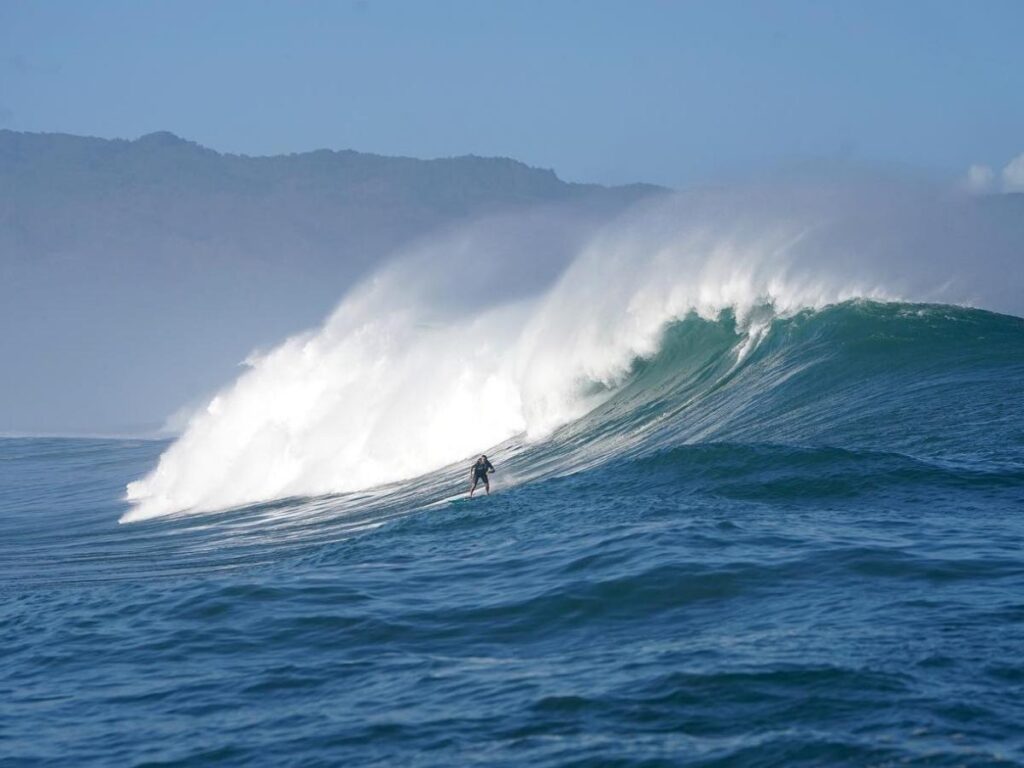 Surfers riding large waves on Oahu’s North Shore in Hawaii