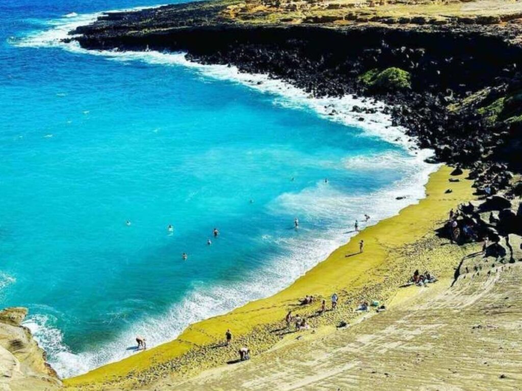 Papakolea Green Sand Beach on the Big Island with green tinted sand and ocean cliffs
