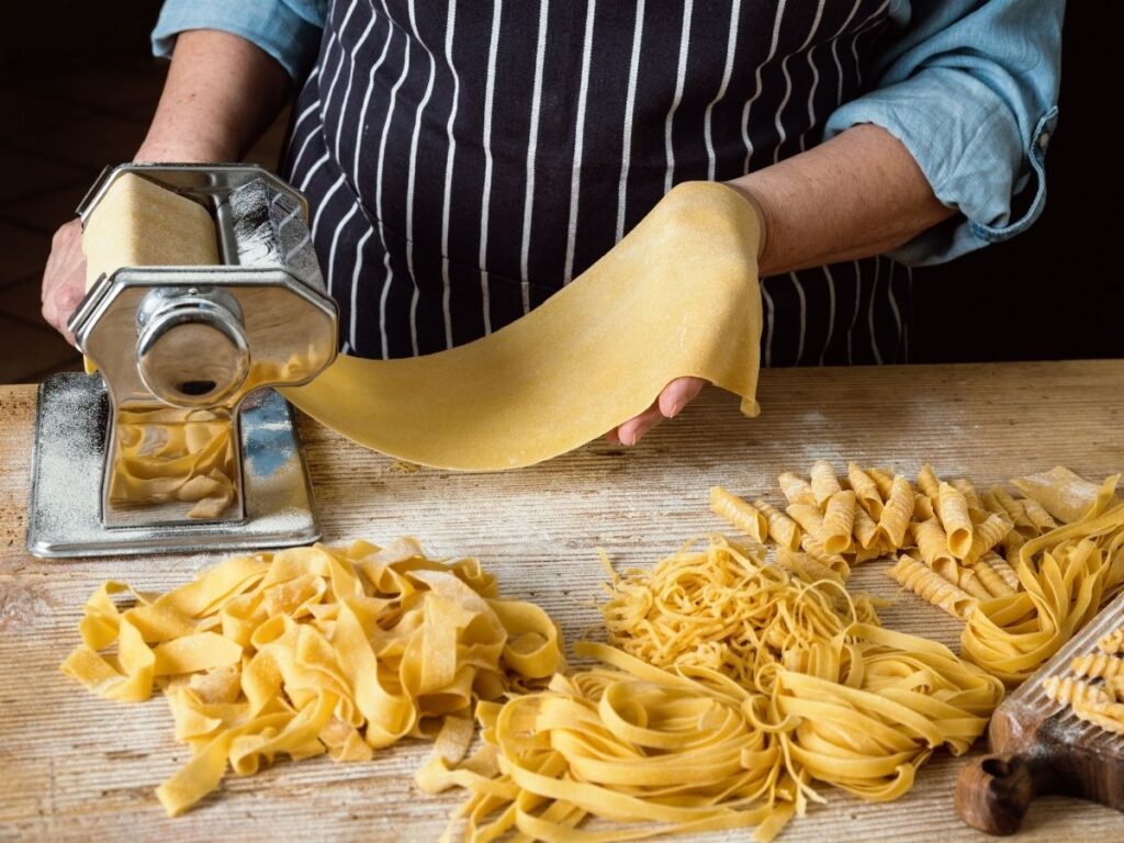 pasta-making class with flour-dusted hands and rolling pin