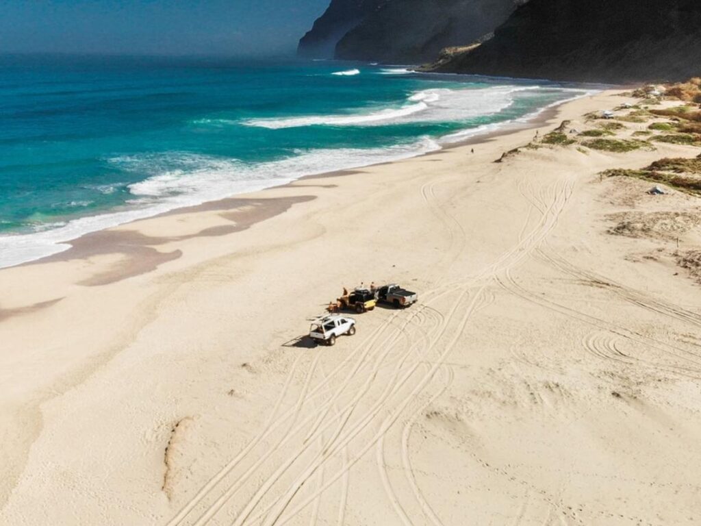 Long sandy shoreline at Polihale Beach on Kauai during sunset