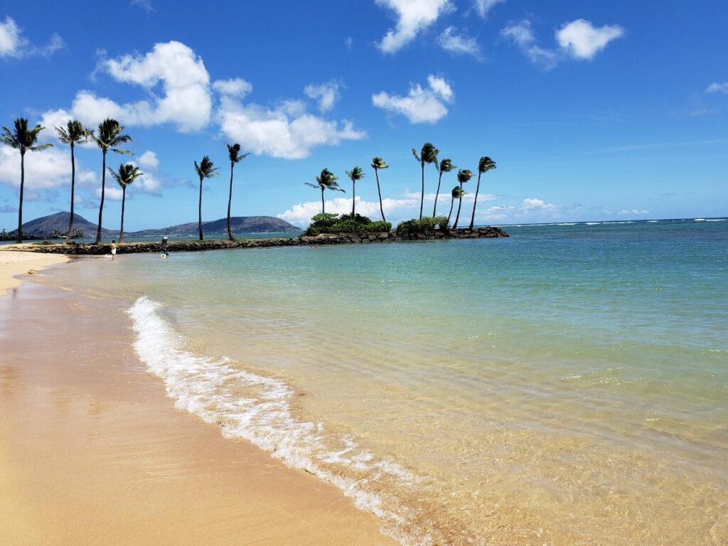 Relaxing beach scene in Hawaii with clear water and sandy shoreline