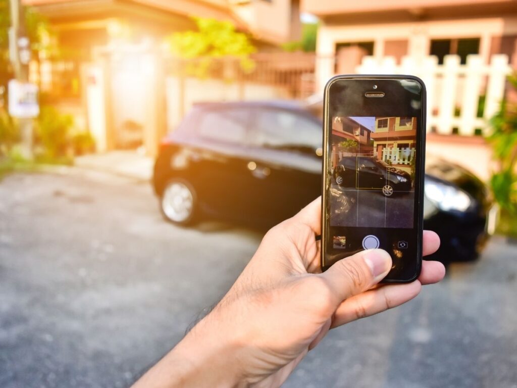 Traveler taking photos of rental car for inspection